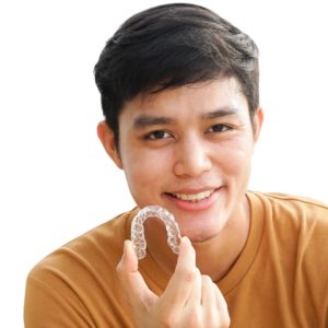 young man holding invisalign tray