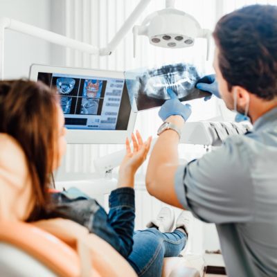 Dentist showing patient dental x-rays